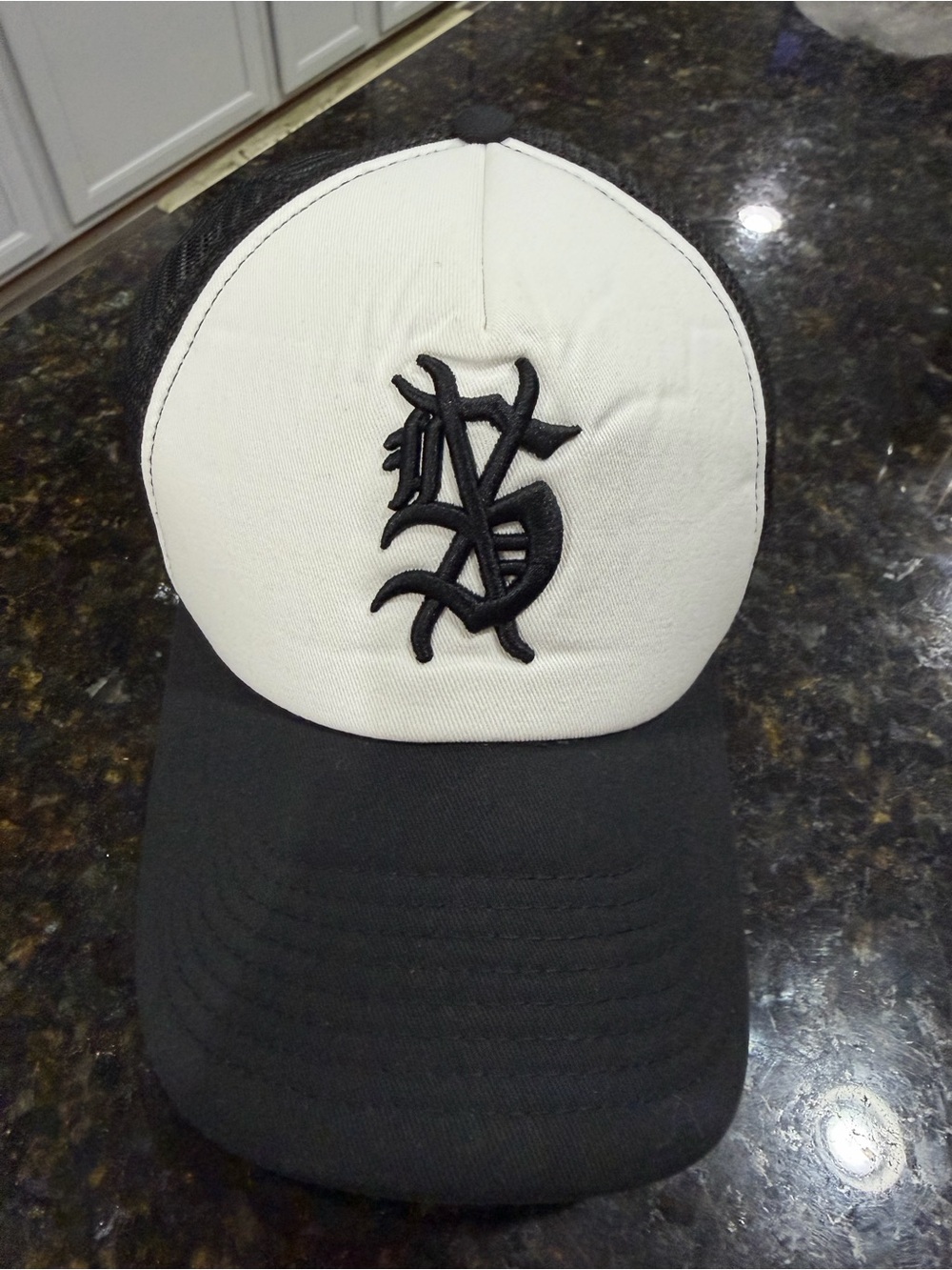 New Era Black and White Trucker Hat with Raised Script Logo